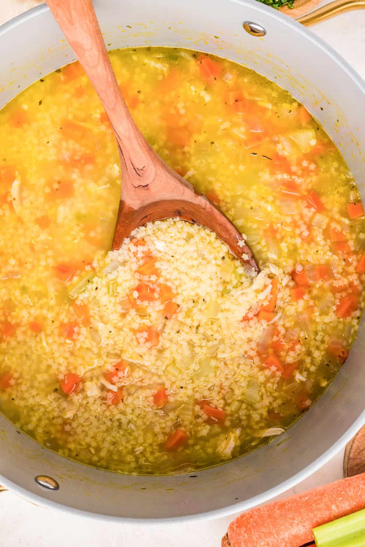 Chicken Pastina in a duch oven with a spoon