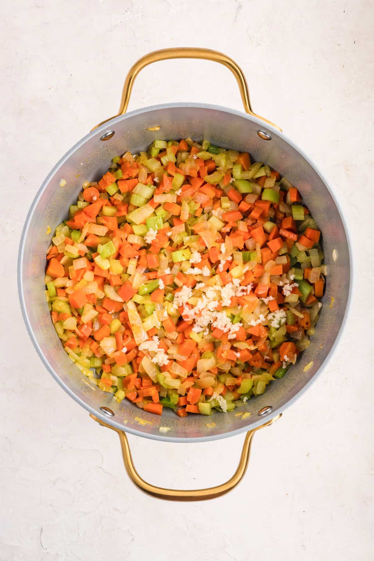 Sauteed vegetable in a pot for Chicken Pastina Soup