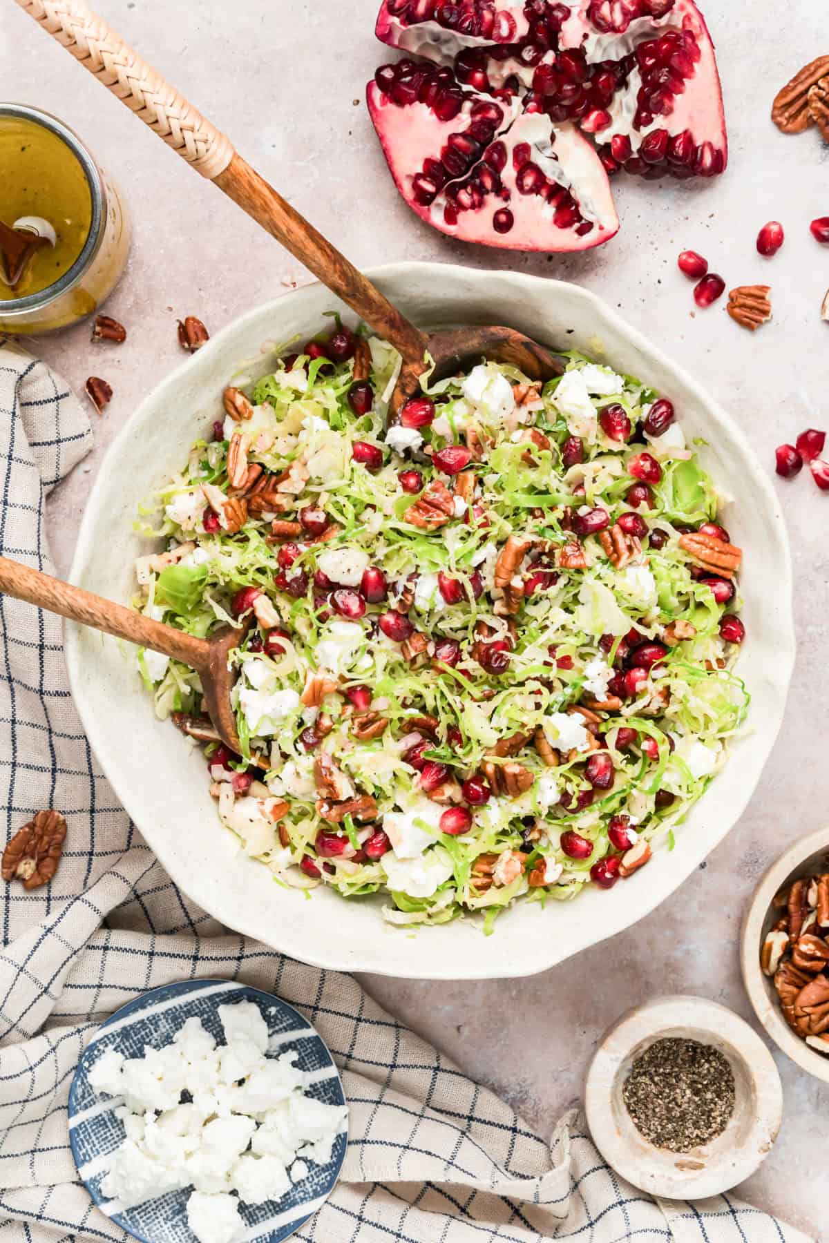Crumbled goat cheese being sprinkled over Brussels sprouts salad